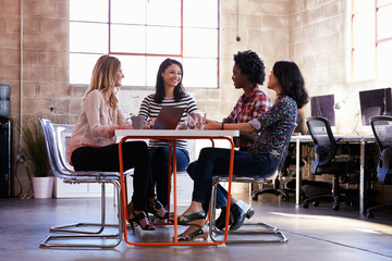 Group Of Female Designers Having Meeting In Modern Office