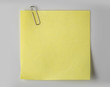 Steel paper clip and Yellow paper on white background