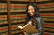 Young attractive female African American law school student in law library

