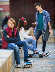 Wall Mural - Offended boy and couple of teens apart