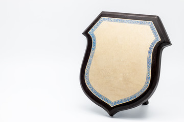 golden shield diploma in wooden frame isolated on white backgrou