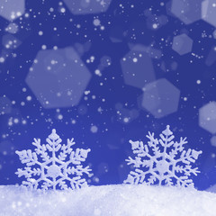 Wall Mural - christmas background with two decorative snowflakes in snow