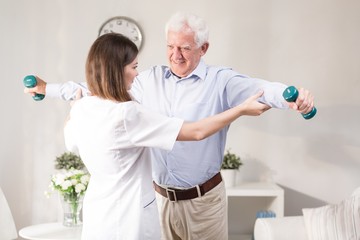 Wall Mural - Nurse helping patient to exercise