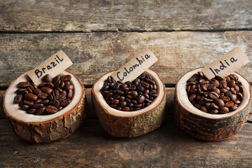 Poster - Collection of coffee beans on old wooden table, close up