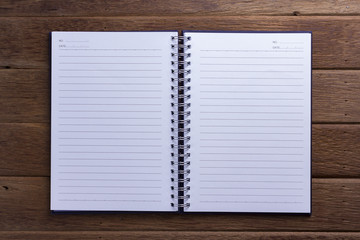 Note book paper  on dark wood background