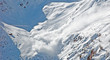 Snow avalanche in the mountains in winter