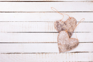 Wall Mural -  Two decorative hearts on white  painted wooden background.