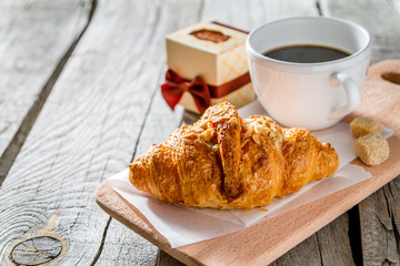 Wall Mural - Delicious fresh croissants with coffee and present