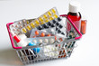 Shopping basket full with pills and medicines on a white background
