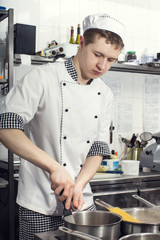 Wall Mural - chef preparing food in the kitchen at the restaurant