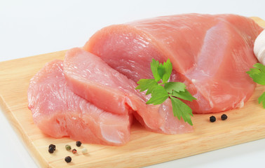 Poster - Raw turkey breast on cutting board