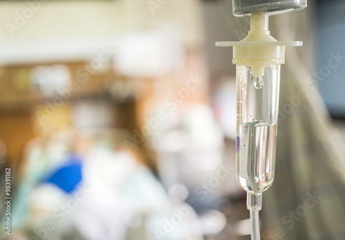 Closeup saline intravenous (IV) drip for patient in hospital. Poster