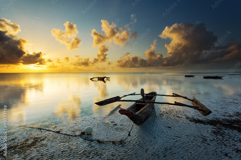 Traditional fisher boat in Zanzibar on a white beach at a beauti - obrazy, fototapety, plakaty 
