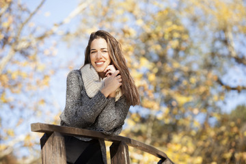 Beautiful happy woman in autumn park,shallow depth of field. Fall season