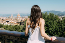 Italy, Florence, woman looking to the city from Piazzale Michelangelo viewpoint