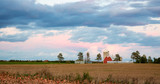 Family Farm Scene with Dramatic Sky at Twilight