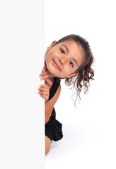 Cute little girl looking at the camera from behind the board