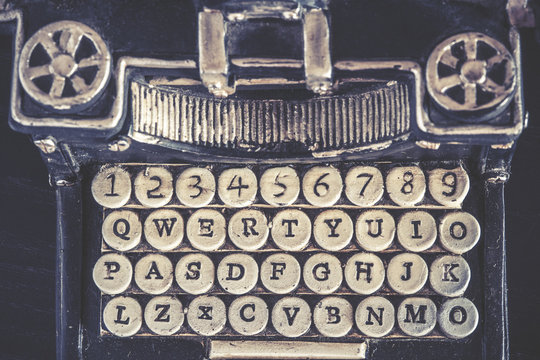 Vintage typewriter detail with stone carved keys photographed with shallow depth of field
