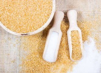 Brown sugar cane on the wooden background.