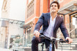 © Sergey Nivens - Successful businessman riding bicycle
