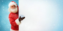 Santa Claus Holding Copyspace Blank Sign For Your Text / Merry Christmas & New Year's Eve Concept / Closeup On Blurred Blue Background.