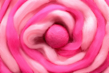 Wall Mural - The spiral curl of wool two shades  closeup. Background made of wool for felting in the form of a Christmas candy