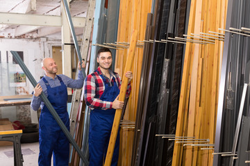 Wall Mural - Two workers choosing PVC window profile