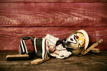 old marionette on a wooden surface, filtered