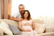© Africa Studio - Handsome man takes care about his lovely pregnant woman