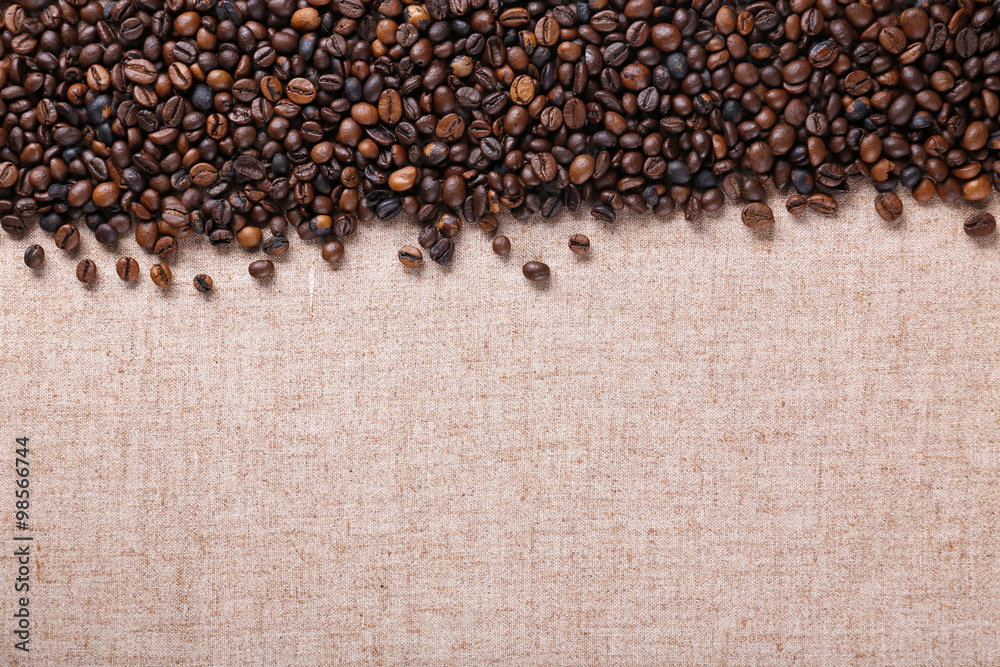 Roasted coffee beans on the linen fabric