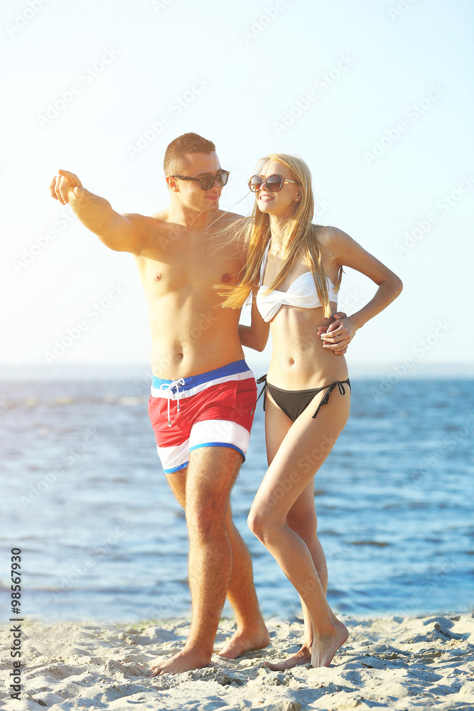 A hugging couple at the beach, outdoors