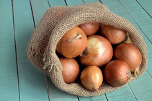 Onions.   Sack With Onions On A Wooden Background.             

 