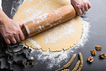 Rolling dough with roller.