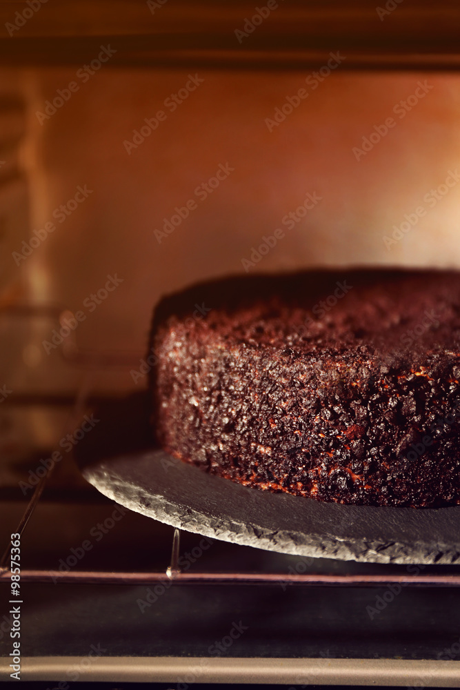 Chocolate cake in oven, close up