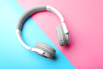 Wall Mural - Wireless white and grey headphones on pink-blue background