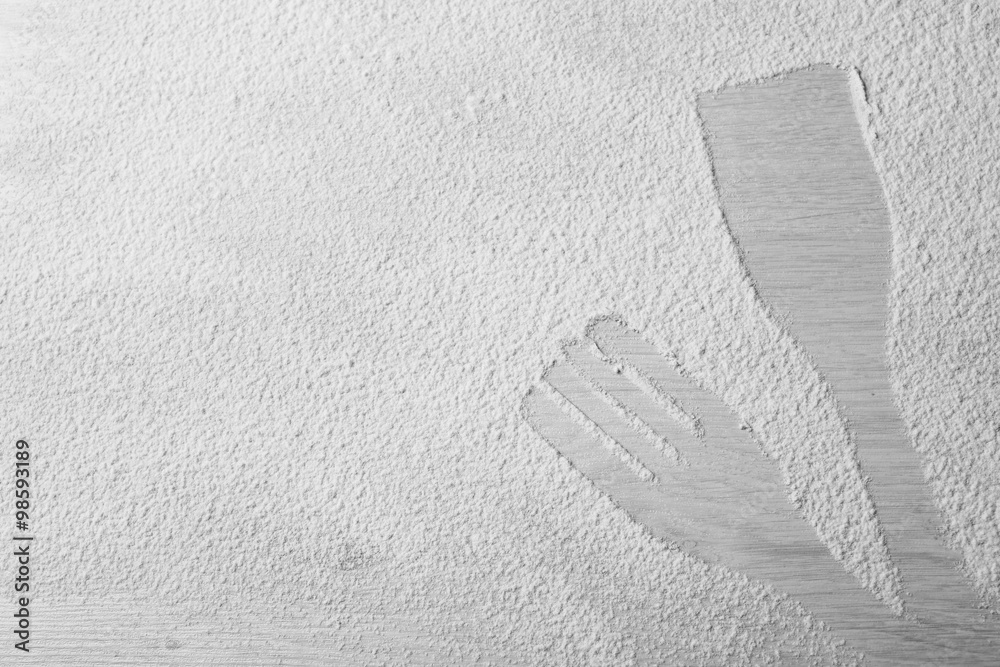 Flour sprinkled around kitchen utensils on light background