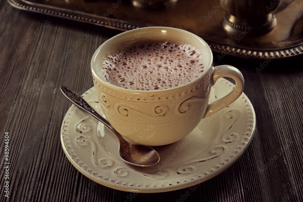 Vintage cup of cacao on wooden background