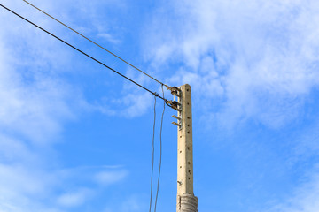 electricity post against blue sky background