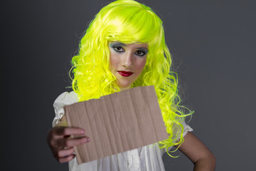 Wall Mural - smile, teenager with fluorescent yellow wig, carrying a cardboar