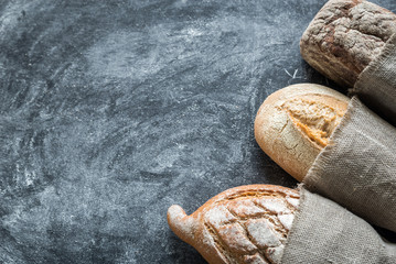 Canvas Print - Whole grain breads on the dark wooden background