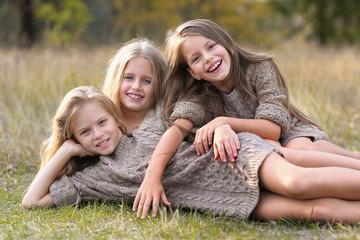 portrait of three girlfriends on the nature