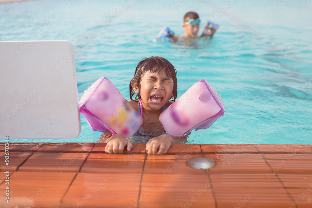 Portrait of Asian girl swimming in swimming pool Stock Photo | Adobe Stock