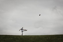 American Football Player Kicking Ball I Field