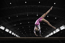 A Gymnast On The Beam Doing A Handstand