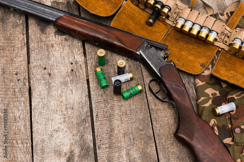 Fotografie, Obraz Hunter's bandolier bag on wooden background