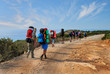 Leinwandbild Motiv group of tourists with large backpacks are on road sea