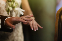 Silver Elegant Wedding Ring On Groom Finger In Church Closeup