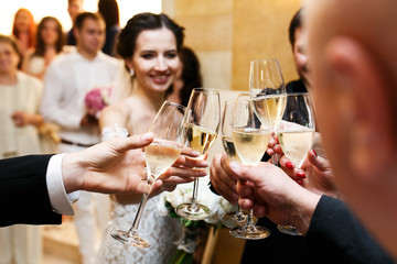 Happy newlywed bride and groom at wedding reception eating and d