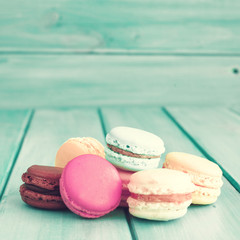 Wall Mural - Colorful macaroons over turquoise wood