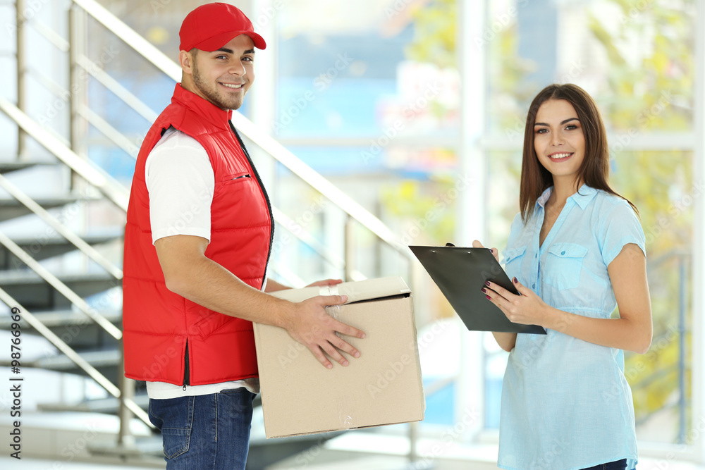 Young woman and courier - delivery concept